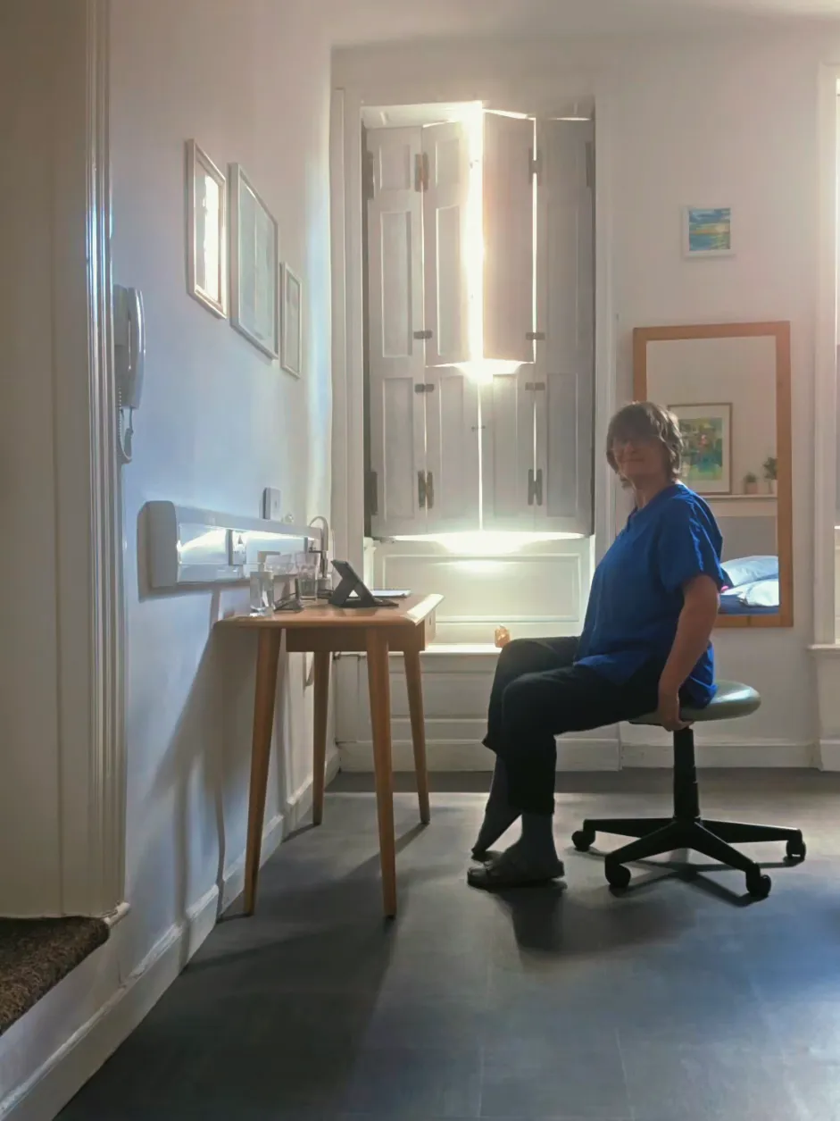 Clare demonstrating: desk stretches