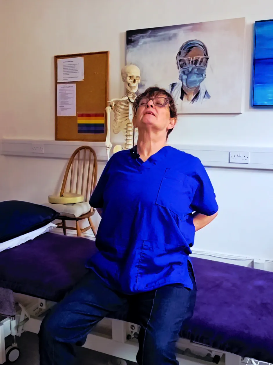 Clare demonstrating: stiff shoulders and a stiff back