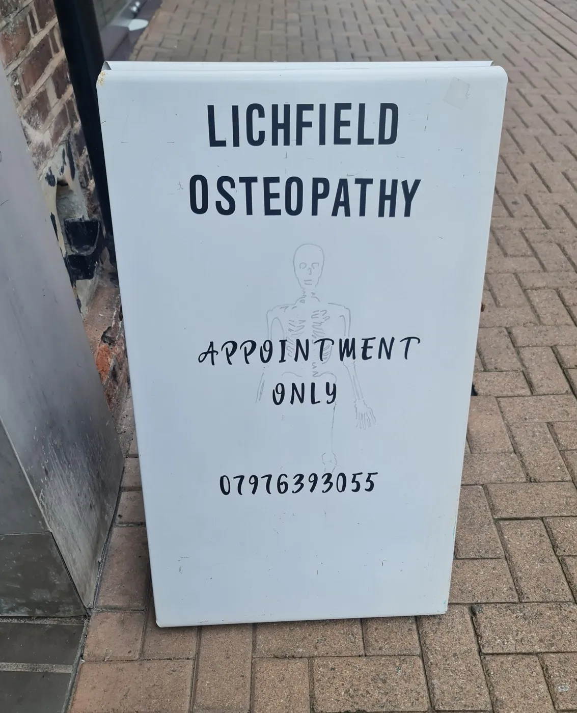 The white Lichfield Osteopathy A-board outside 7 Market Street