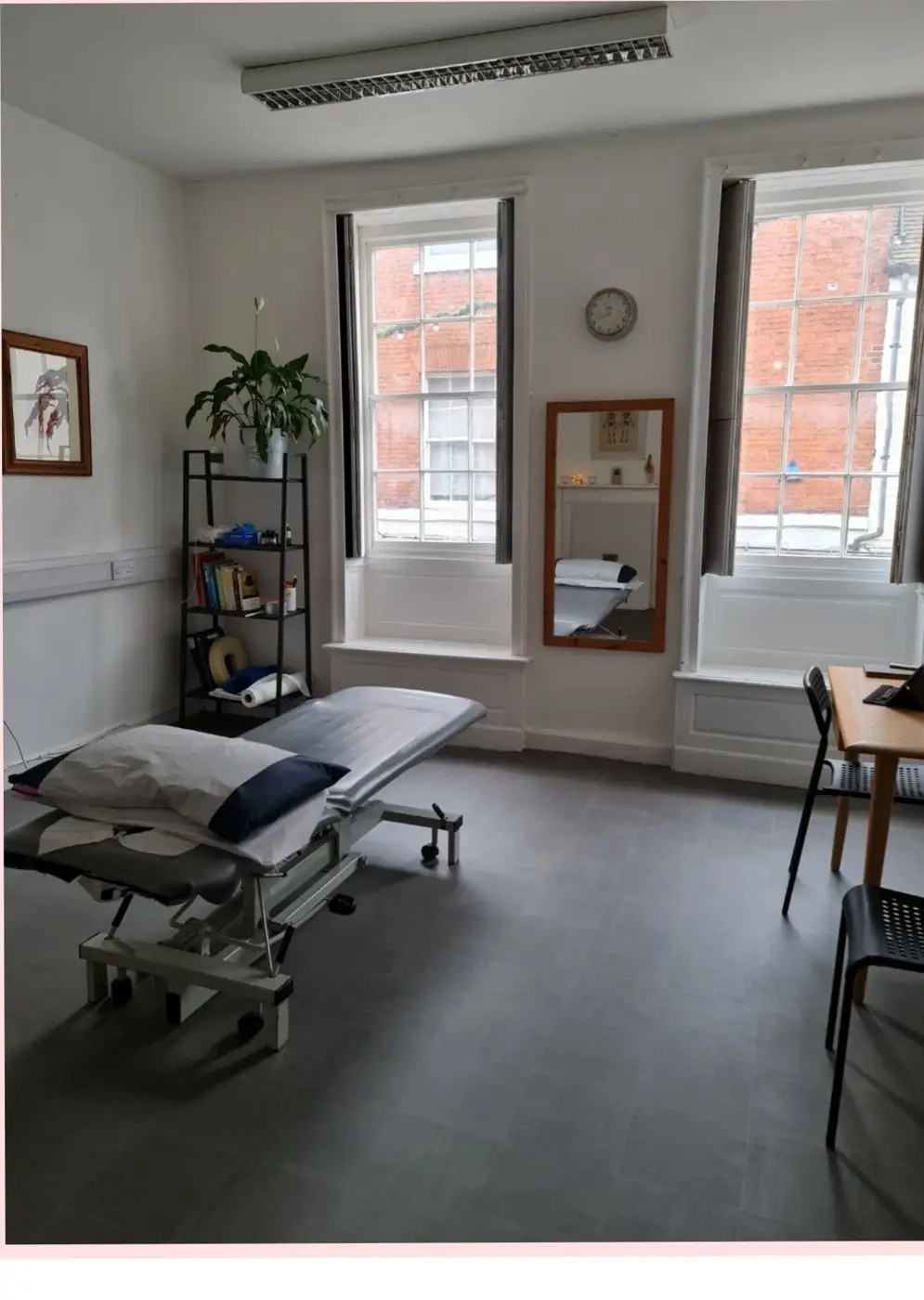 The treatment room at Lichfield Osteopathy, with two Georgian sash windows onto Market Street
